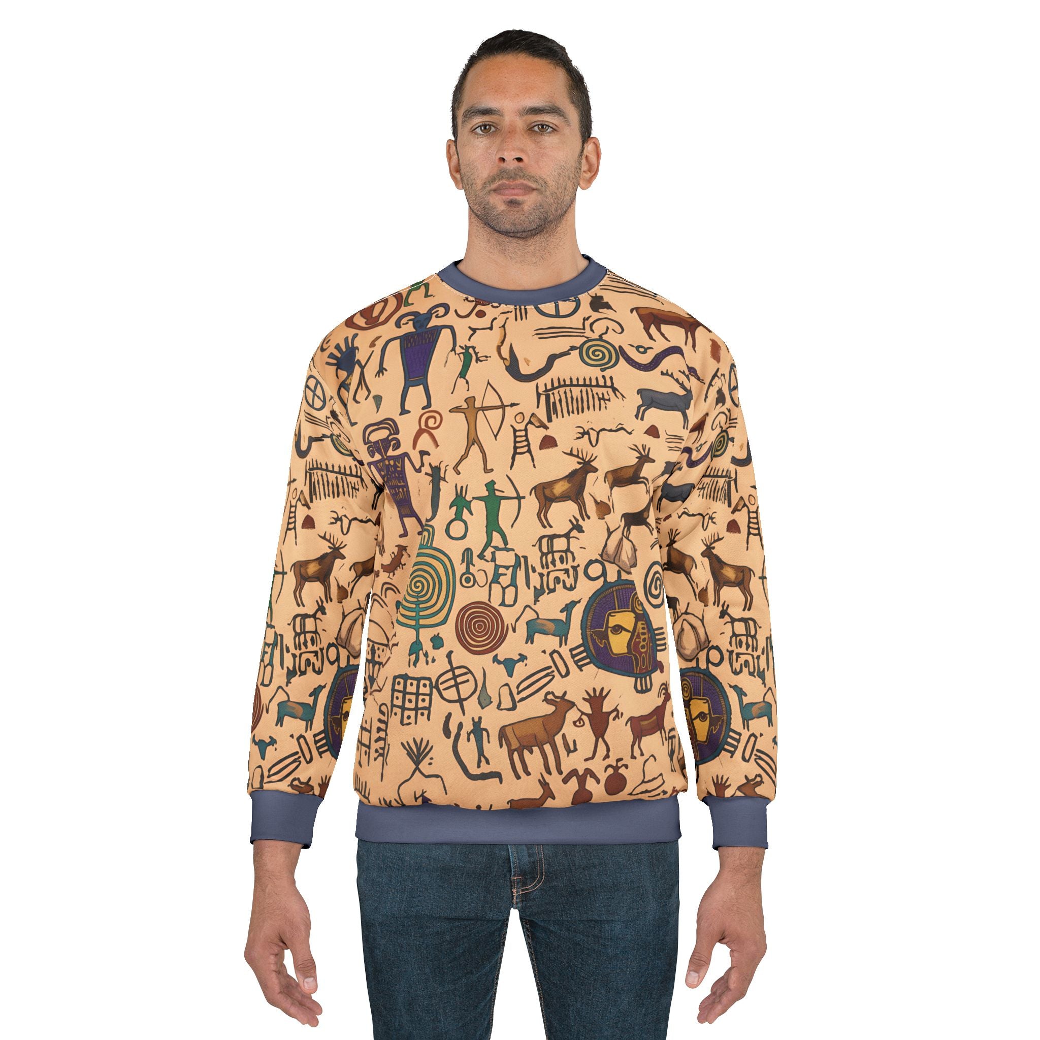 Tan petroglyph print sweatshirt worn, long sleeves, blue ribbed cuffs and hem