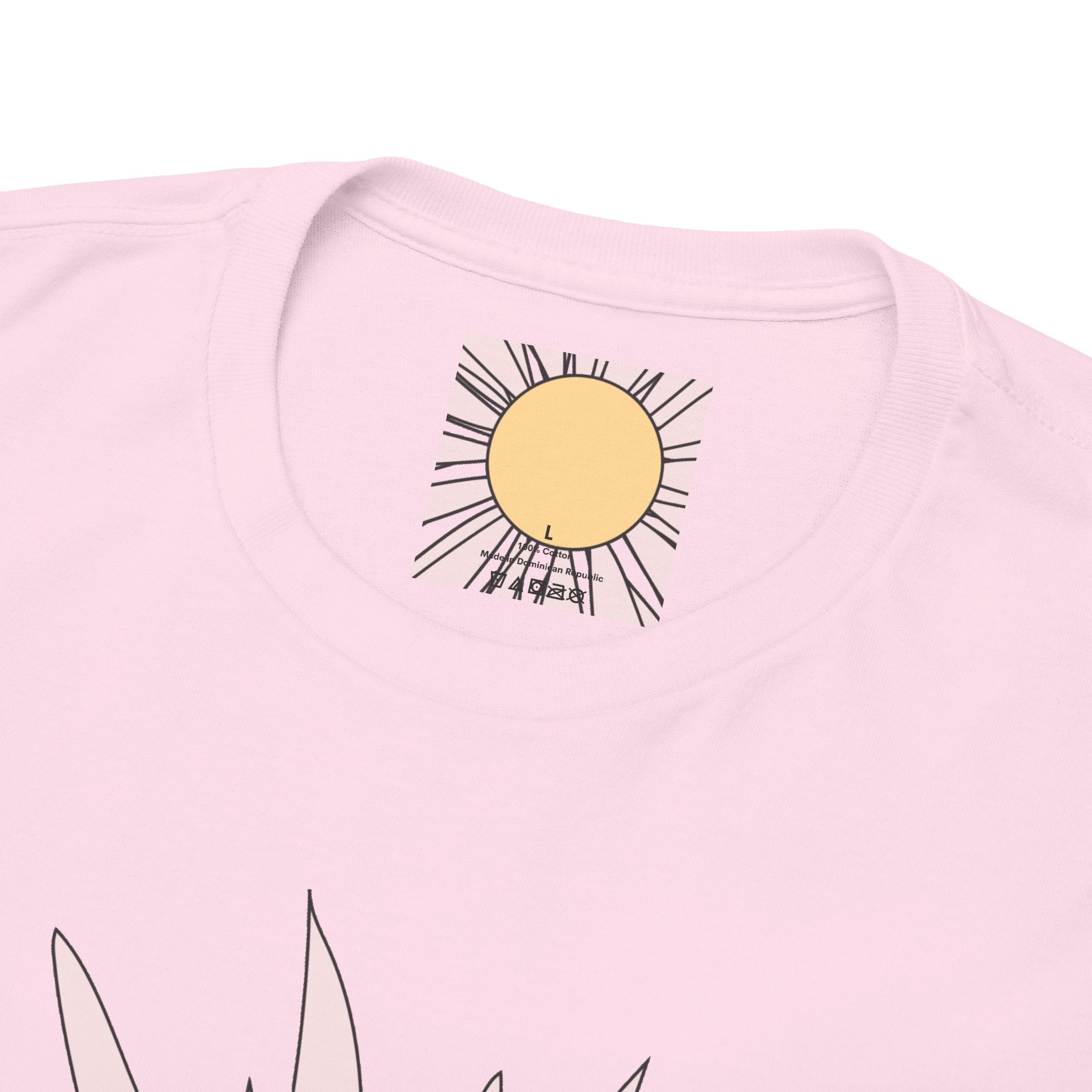 Close-up of light pink tee neckline with small daisy flower graphic above collar