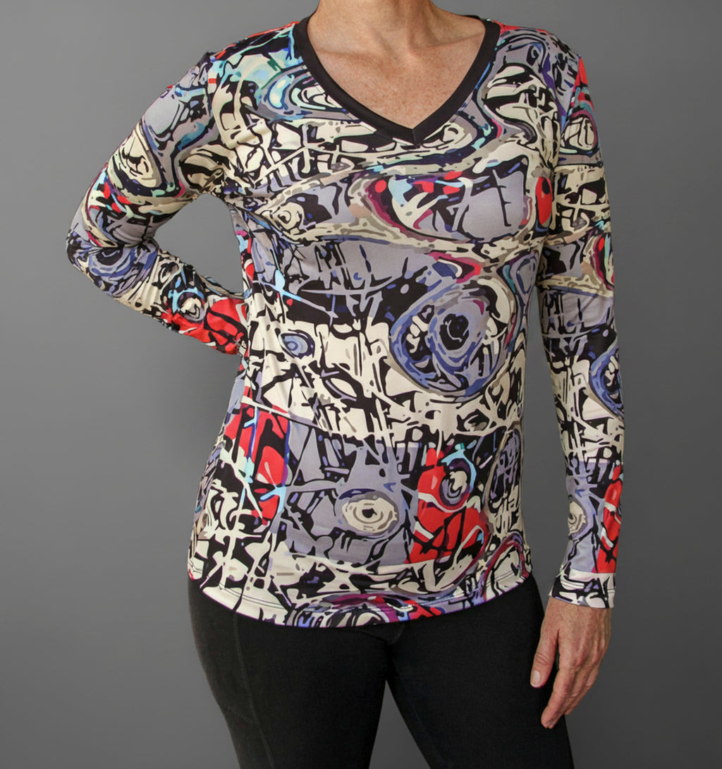 Graffiti V-neck long-sleeve shirt on model, multicolor abstract print, black trim V-neck