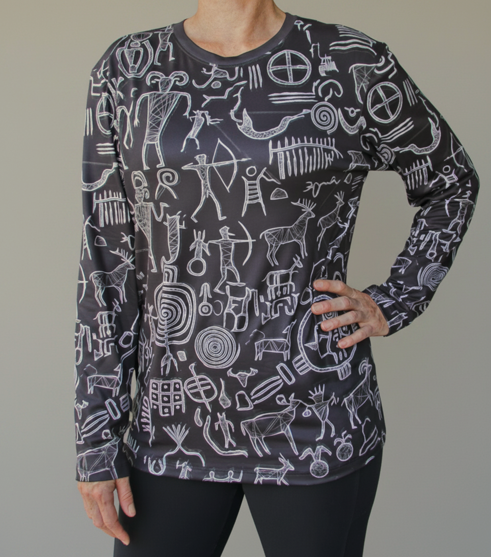 Black long-sleeve shirt with white tribal petroglyph pattern, crew neck on model