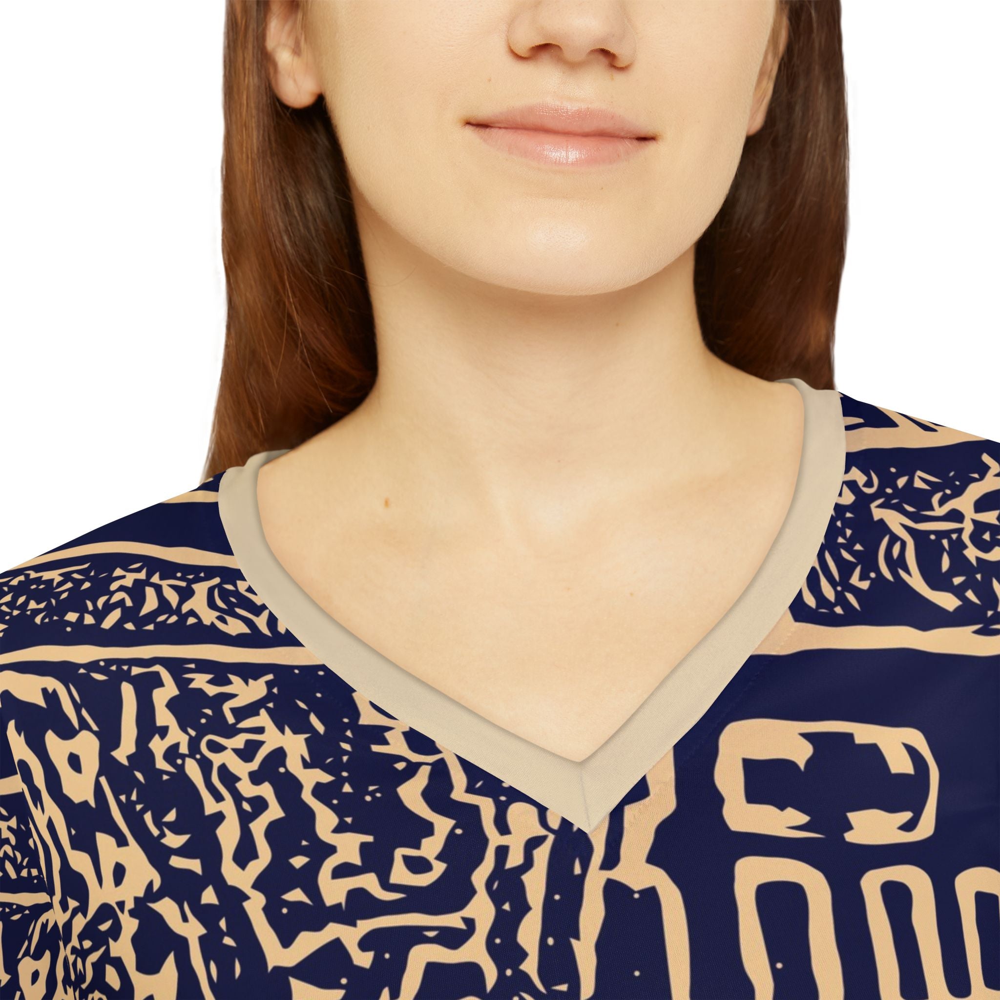 Close-up of women’s navy V-neck patterned top with beige-trim collar and abstract print