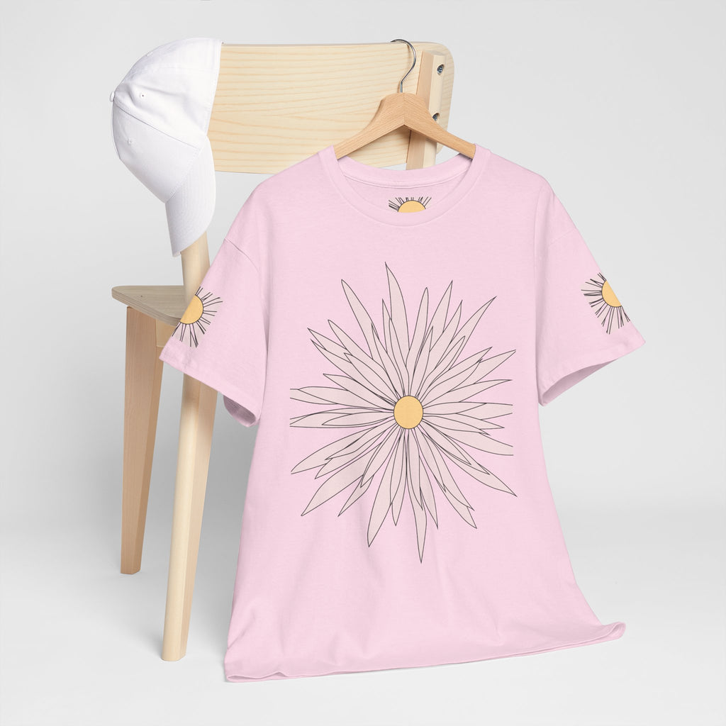 Light pink graphic tee on a wooden hanger with large daisy flower print and sleeve daisy details.