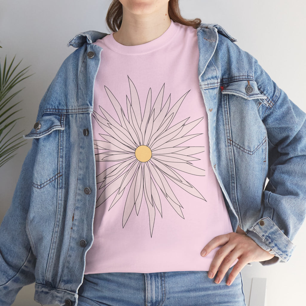 Light pink graphic tee front chest view with large daisy flower print and yellow center.