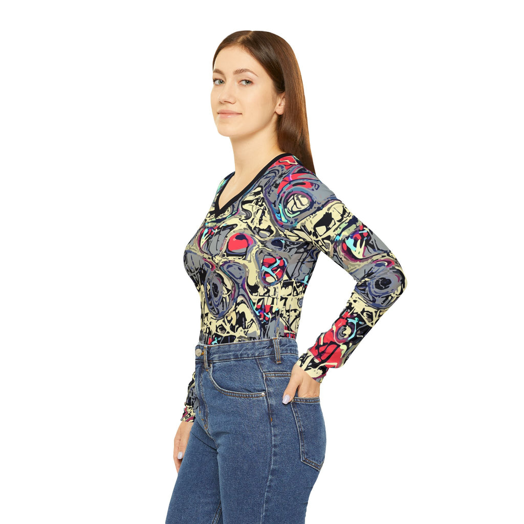 Abstract graffiti v-neck long-sleeve top, side view with dark neckline and sleeve cuffs.